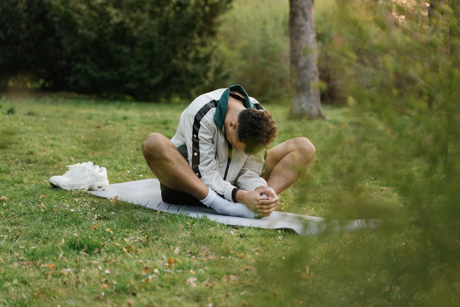 Person holding a tree yoga pose, showing balance and concentration in nature.