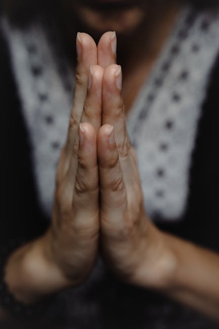 Person meditating cross-legged on a yoga mat with hands in a gyan mudra gesture.
